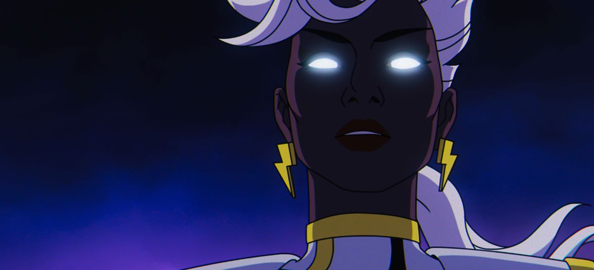 A closeup of Storm's face as her eyes glow with white energy in X-Men '97. She wears her superhero uniform while levitating during a night fight.