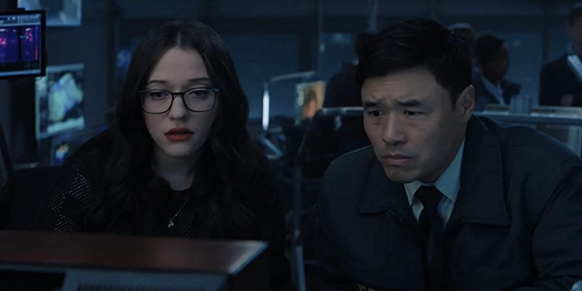 Jimmy Woo (Randall Park) and Darcy Lewis (Kat Dennings) look at a screen with concern on their faces in WandaVision
