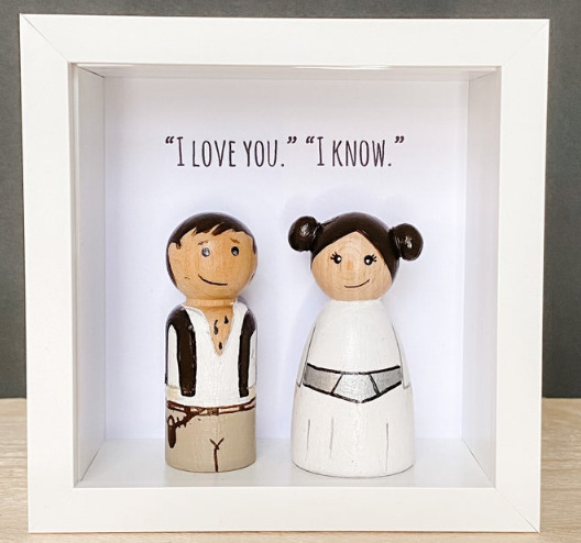 Peg dolls of Han Solo and Princess Leia with the quote I love you and I know. 