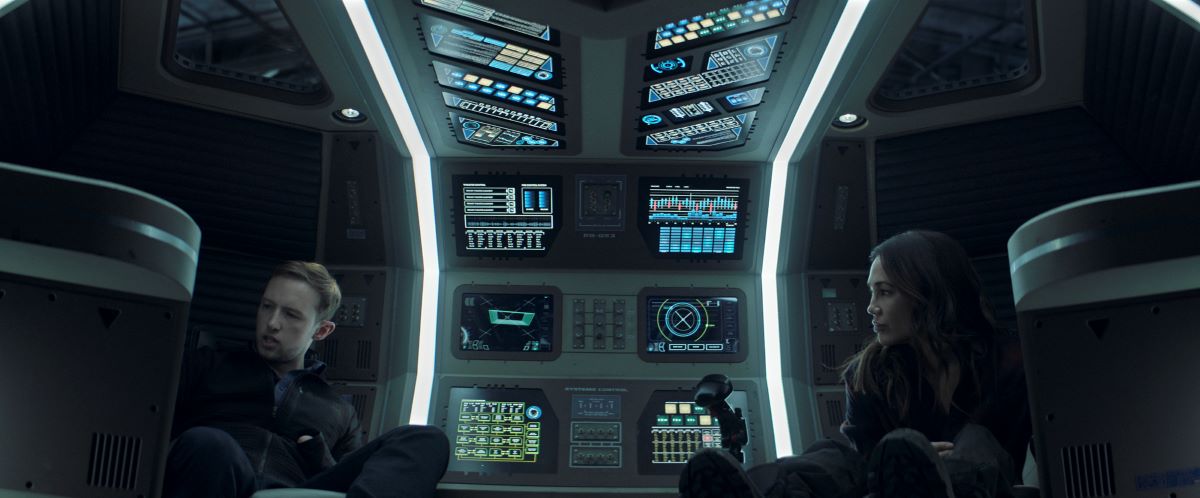 Erich and Clarissa Mao sit in a shuttle while talking in The Expanse Season 5. 