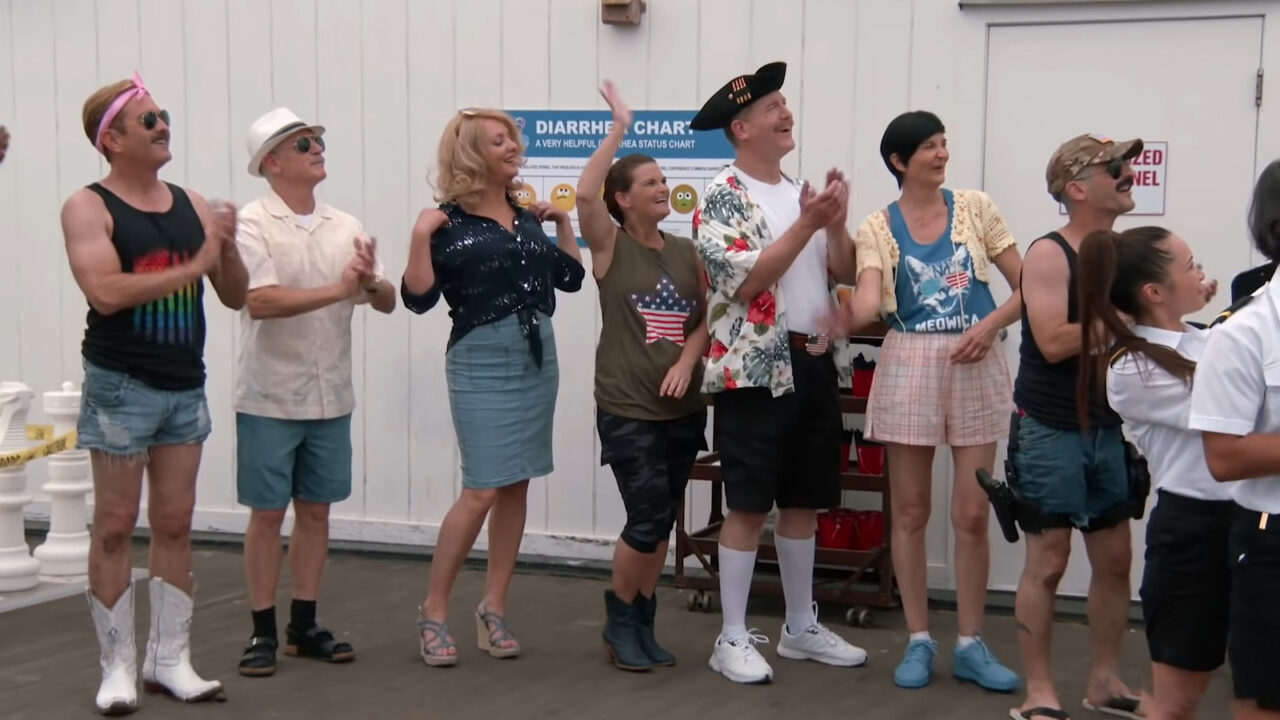 The Reno Deputies line up for pre-cruise health checks in Reno 911!: The Hunt for QAnon, including Clemmy (played by Wendi McLendon-Covey).