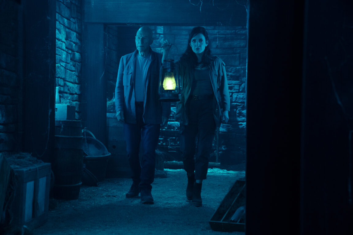 Tallin and Picard travel the tunnels below the chateau with a lantern on the episode "Hide and Seek"