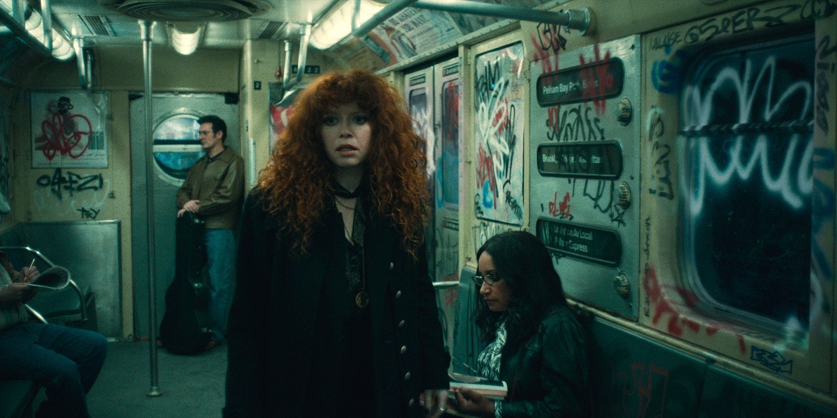 Natasha Lyonne as Nadia, walking in a subway car with graffiti on the walls on Russian Doll Season 2 Episode 6 "Schrödinger's Ruth"