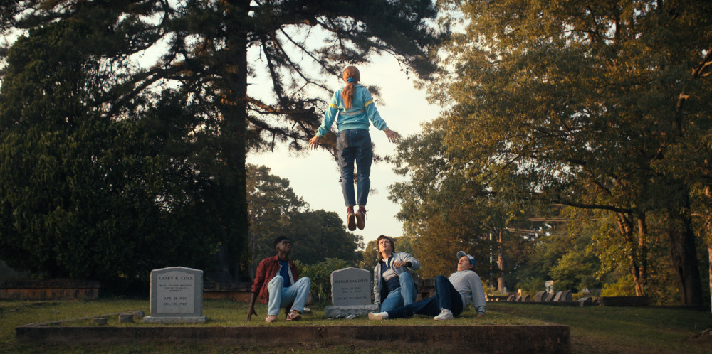 Max floating above her brother Billy's grave while Lucas, Steve and Dustin watch in fear.