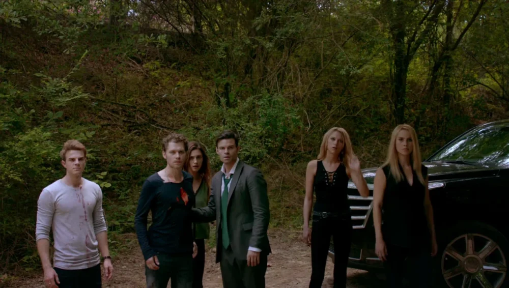 The Mikaelson family standing together outside.