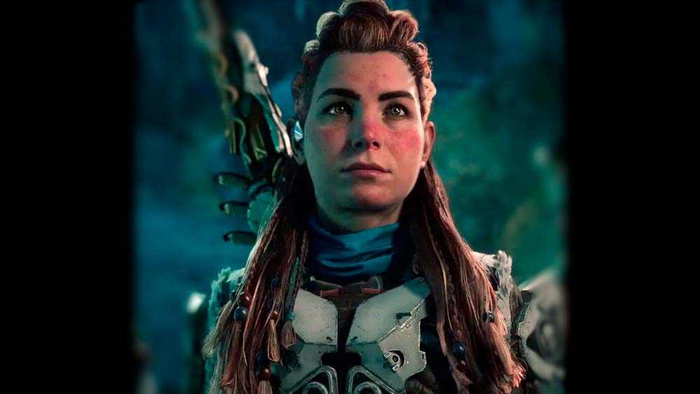 Aloy is featured, from chest up, before a green and blue background. She wears white metallic armor, has a blue cloth at her neck, and her red hair has red and blue beads in it.