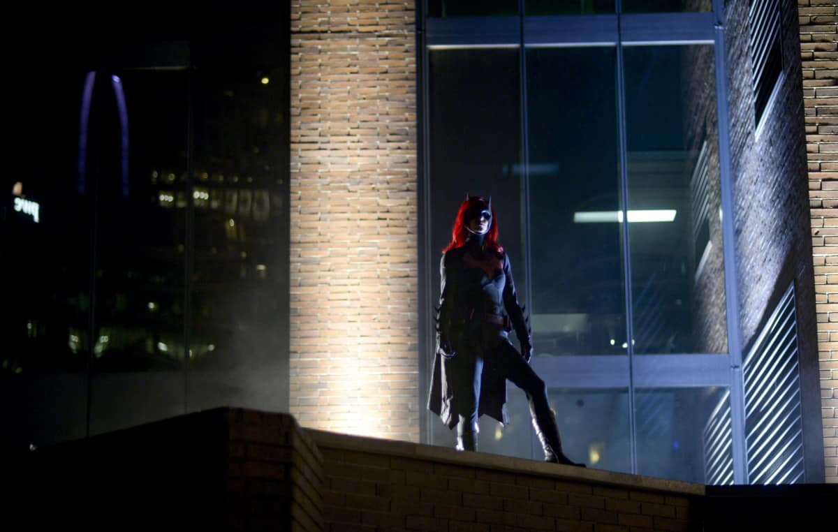 Batwoman standing on a rooftop looking out
