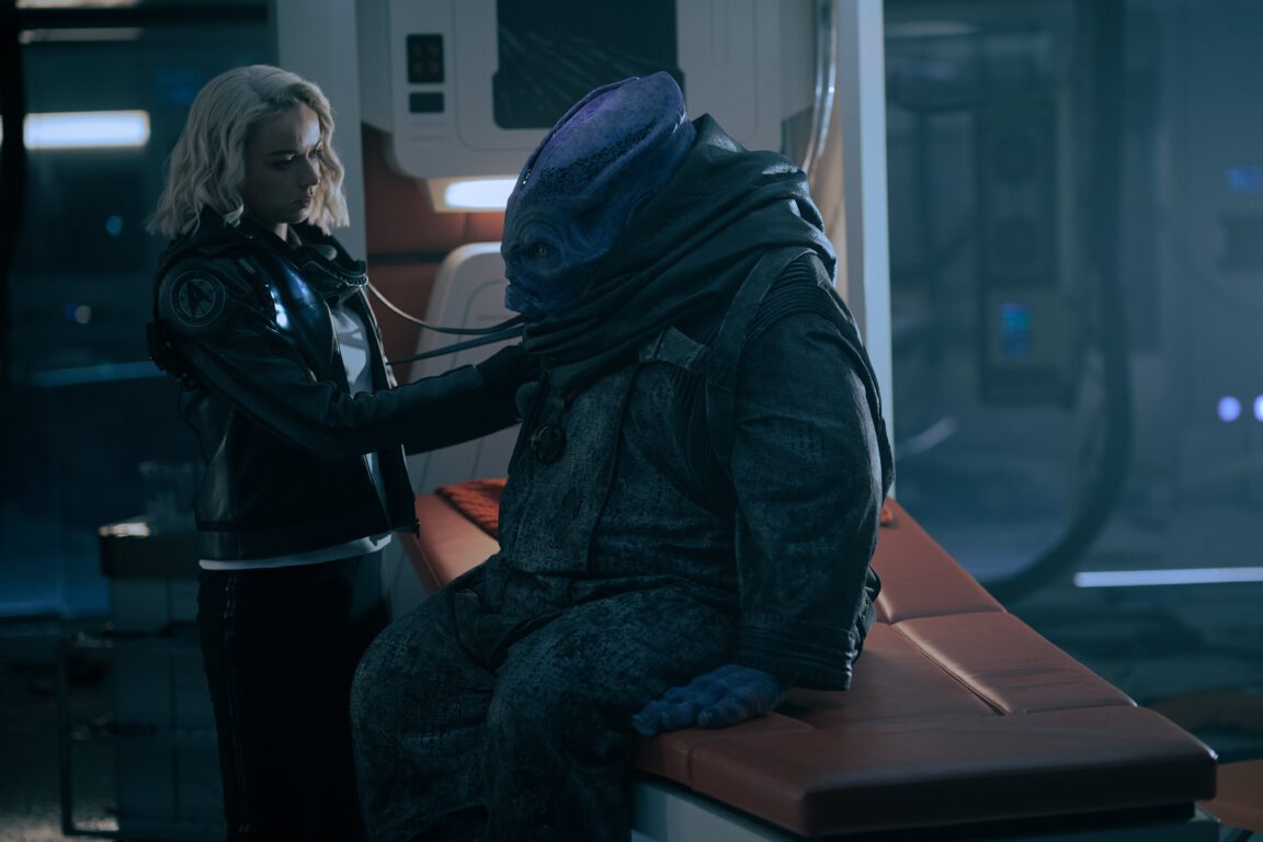 Buckley (Carlos Albornoz) is examined by Nurse Chapel (Jess Bush) in Star Trek: Strange New Worlds.