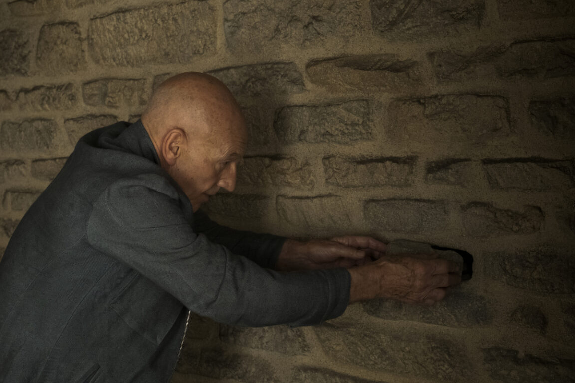 Patrick Stewart as Picard replacing the key in the wall in Chateau Picard.
