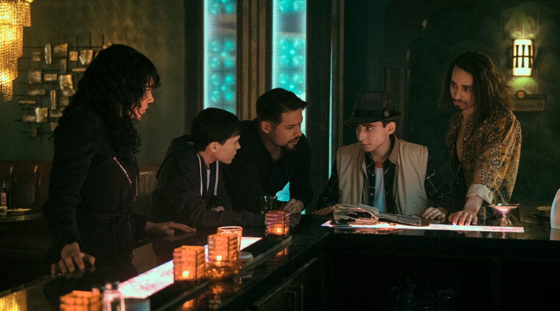 Allison, Viktor, Diego, Five and Klaus crowded around a bar on The Umbrella Academy Season 3 Episode 5 "Kindest Cut."