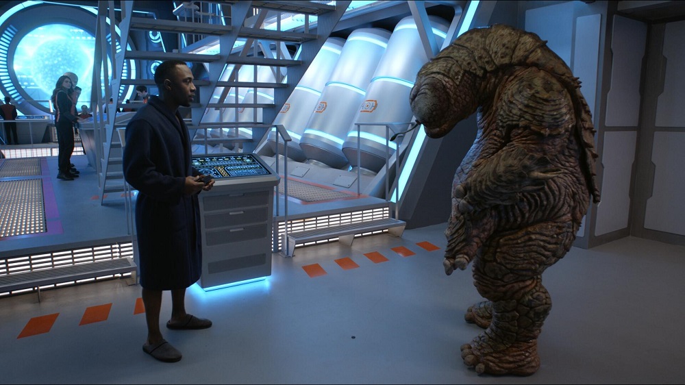Lt. Cmdr. John LaMarr standing in a darkened room in The Orville: New Horizons Season 3 Episode 1 "Electric Sheep."