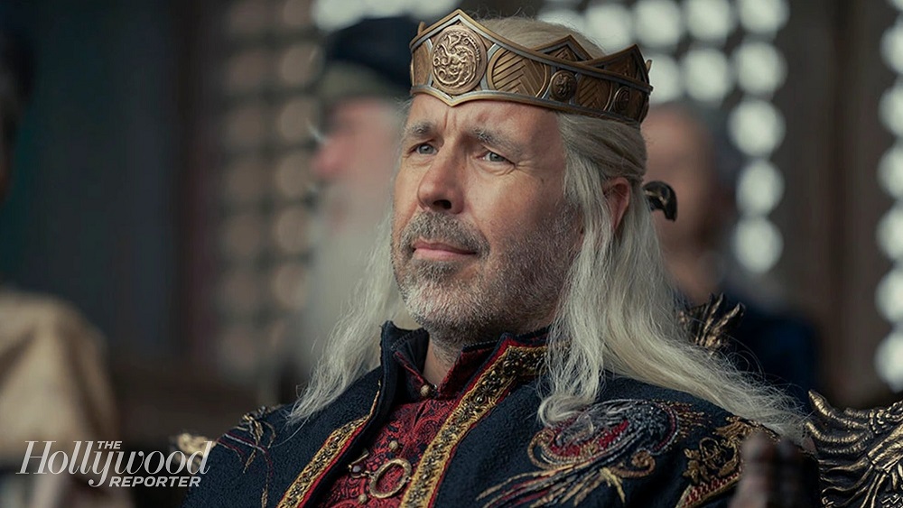 Paddy Considine as King Viserys I Targaryen, sitting while looking out into a crowd serenely on House of the Dragon.