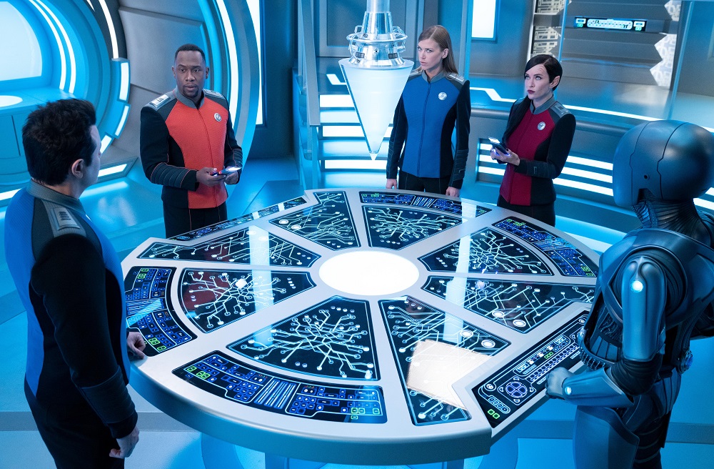 Capt. Ed Mercer, Lt. Cmdr. John LaMarr, Cmdr. Kelly Grayson, Lt. Cmdr. Talla Keyali and Isaac stand around the Aronov device on The Orville: New Horizons Season 3 Episode 6 "Twice in a Lifetime."