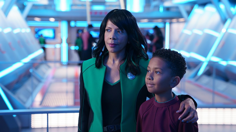Dr. Claire Finn and her son Ty stand arm in arm on The Orville: New Horizons Season 3 Episode 9 "Domino."