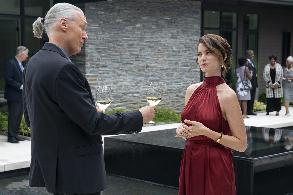 Terry Silver chats with Amanda LaRusso at a swanky cocktail party in Cobra Kai Season 5.