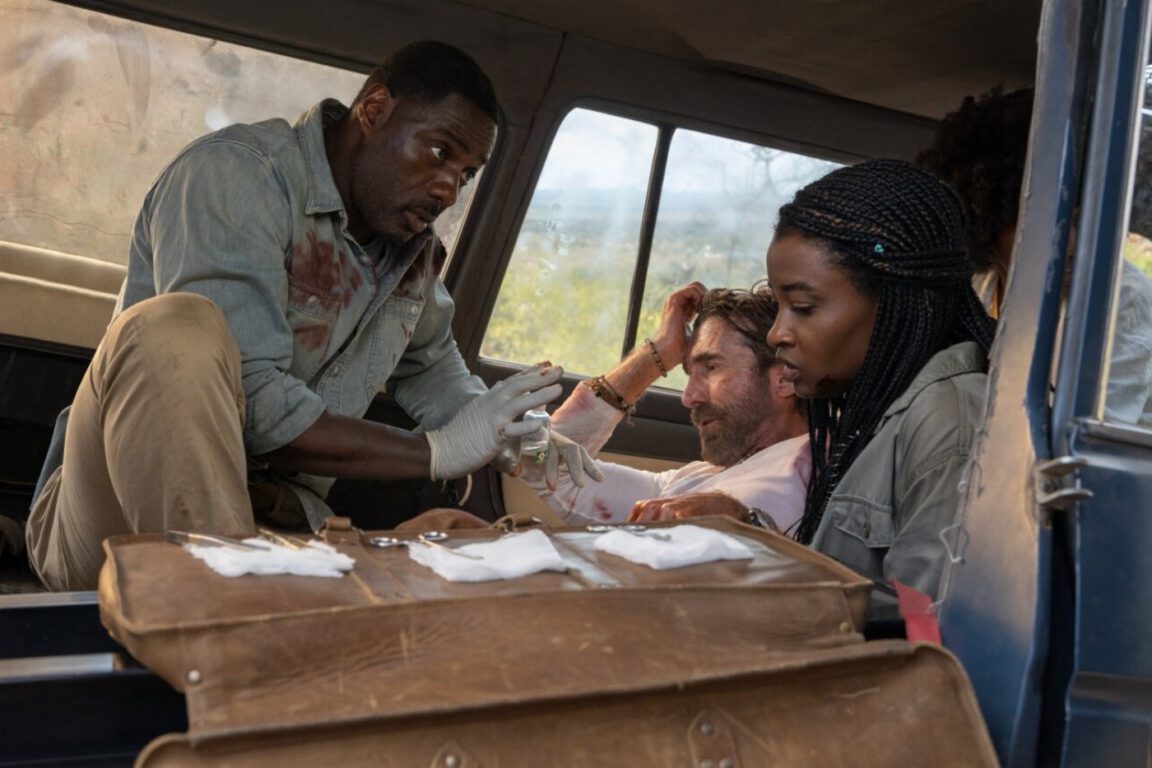Idris Elba and Iyana Halley provide medical care to Sharlto Copley in Beast