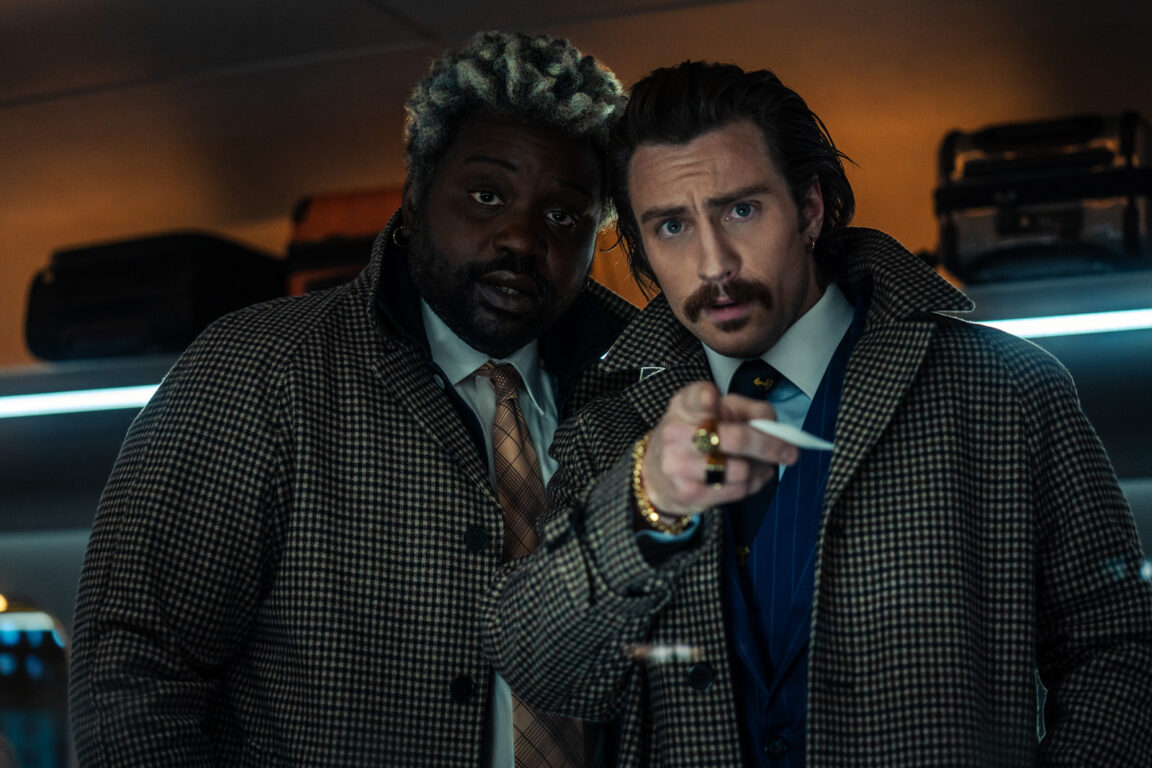Brian Tyree Henry and Aaron Taylor-Johnson point out the trouble in Bullet Train.