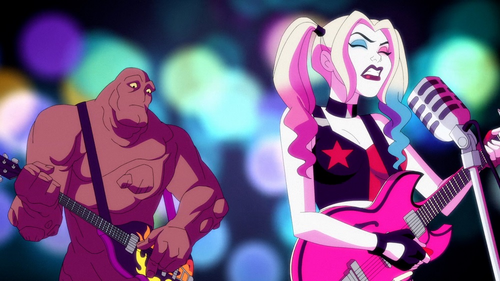 Harley plays guitar and sings while Clayface stands behind her while playing the bass guitar on Harley Quinn Season 3 Episode 4, "A Thief, A Mole, An Orgy."