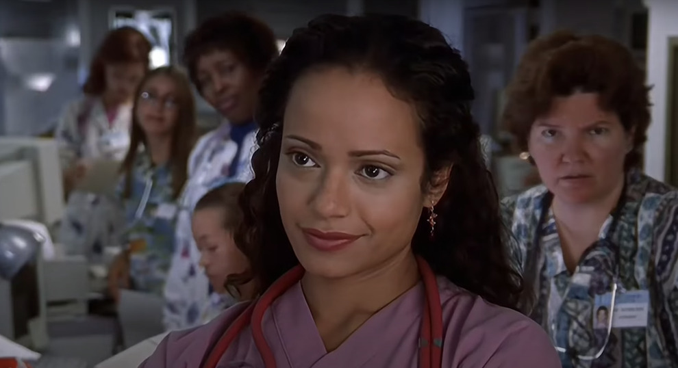 Carla (Judy Reyes) standing in the hallway of Sacred Heart.
