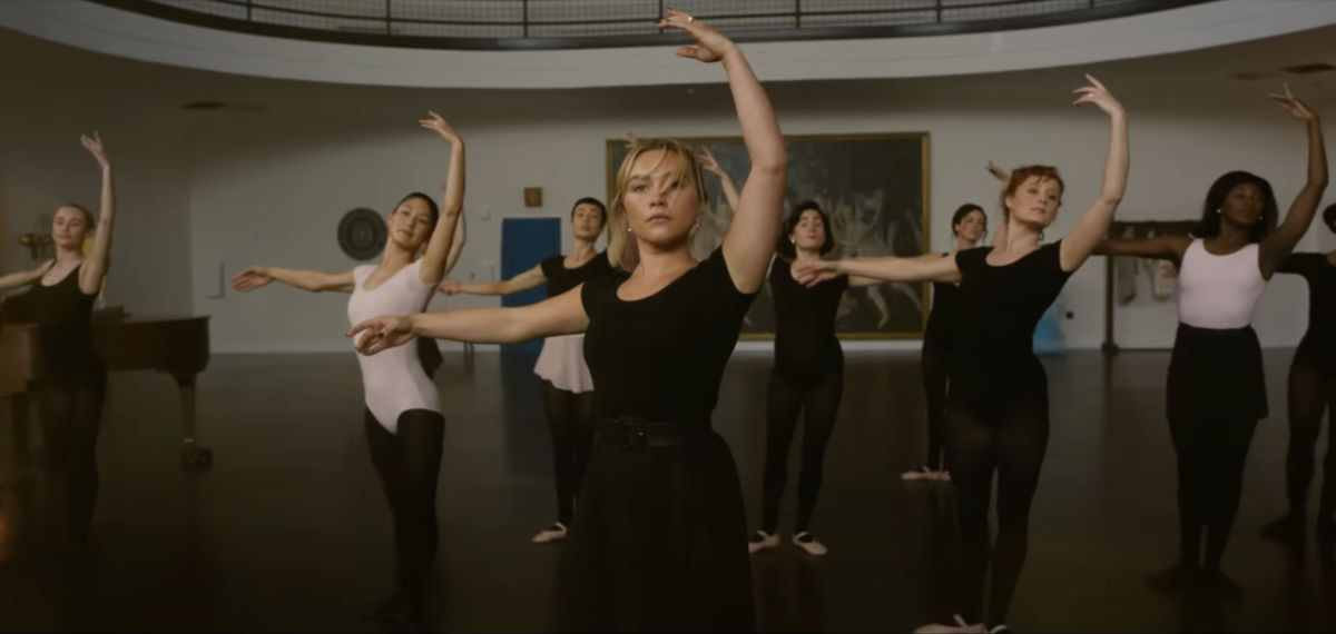 Alice wears a black leotard while dancing in a ballet class in Don't Worry Darling