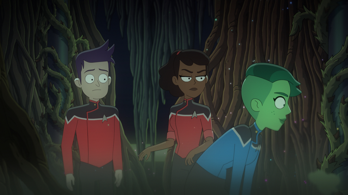 Jack Quaid as Ensign Brad Boimler, Tawny Newsome as Ensign Beckett Mariner, and Noel Wells as Ensign Tendi observing a Tamarian Devron Root in the swampy Cerritos root room.