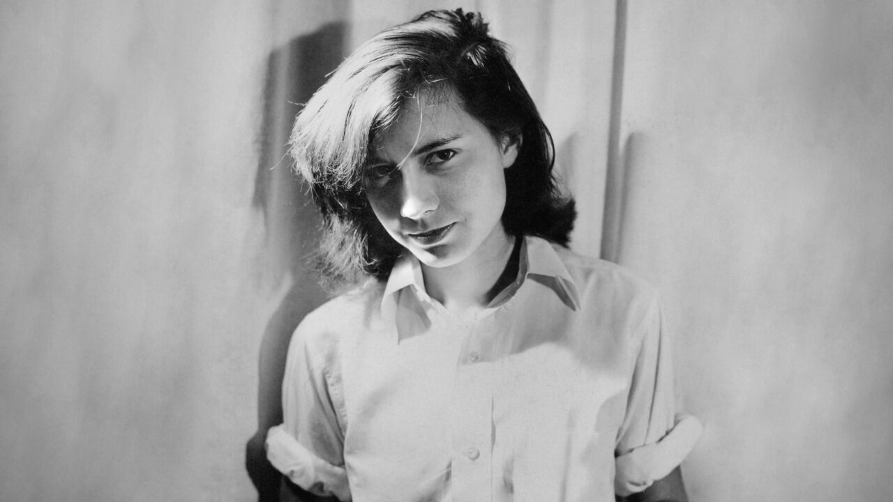A young Patricia Highsmith stares at the camera in a still for Loving Highsmith.