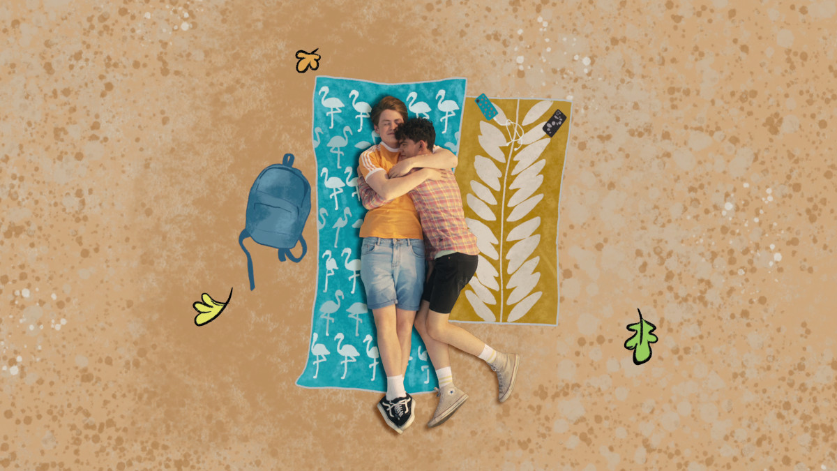 Nick and Charlie cuddling on the beach in Heartstopper.