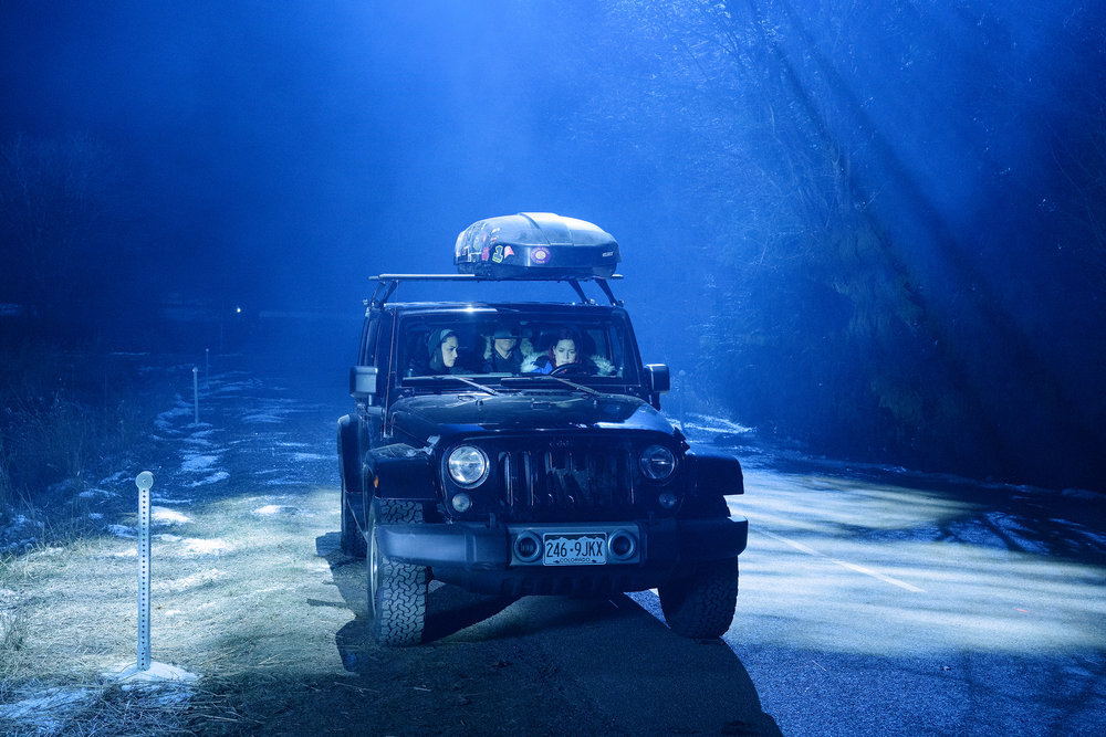 Asta, D'Arcy and Harry sit in D'Arcy's jeep outside at night on Resident Alien Season 2 Episode 13, "Harry, a Parent."