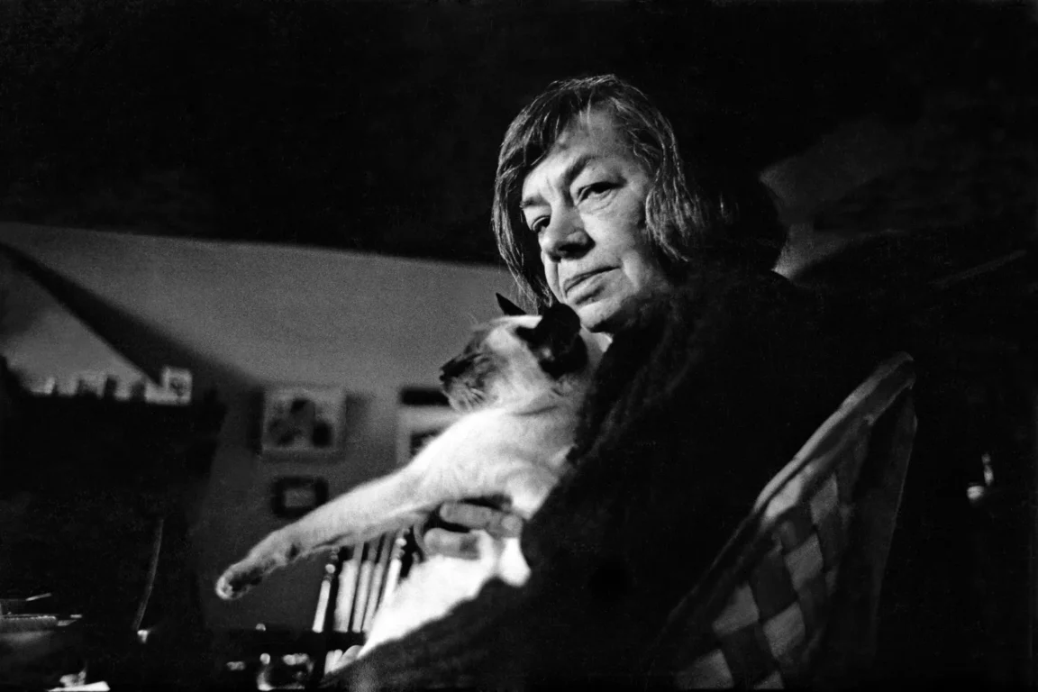 Patricia Highsmith clutches a cat.