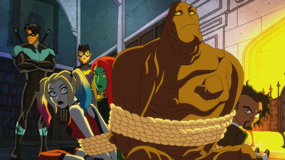 Clayface, Harley, Ivy and Psycho are tied up with rope and sitting near a fireplace in Wayne Manor on Harley Quinn Season 3 Episode 9, "Climax at Jazzapajizza."