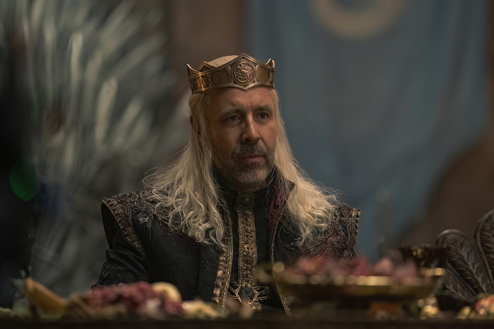 Viserys sits at a table for a feast on House of the Dragon Season 1 Episode 5.