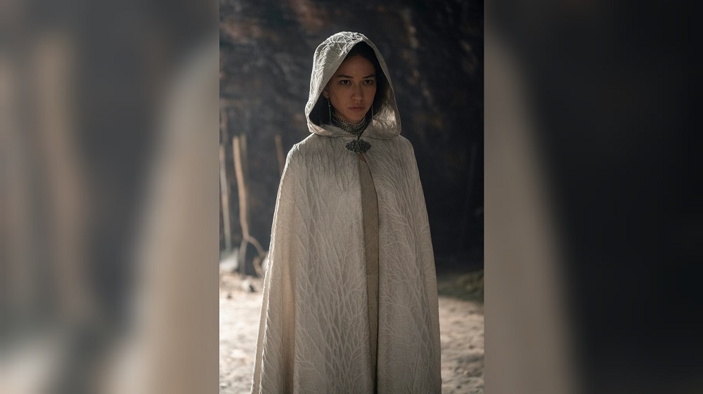 Mysaria wears a white cloak while standing in a cavern and looking determined in House of the Dragon.