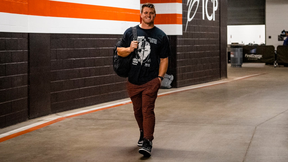 Johnny Stanton walking into practice wearing a smile and a Jason Vorhees tshirt.