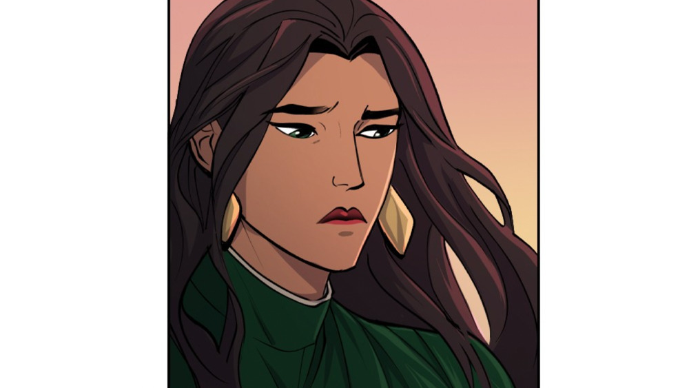 Talia al Ghul, a woman with long dark hair, dangling gold earrings, and a pensive expression