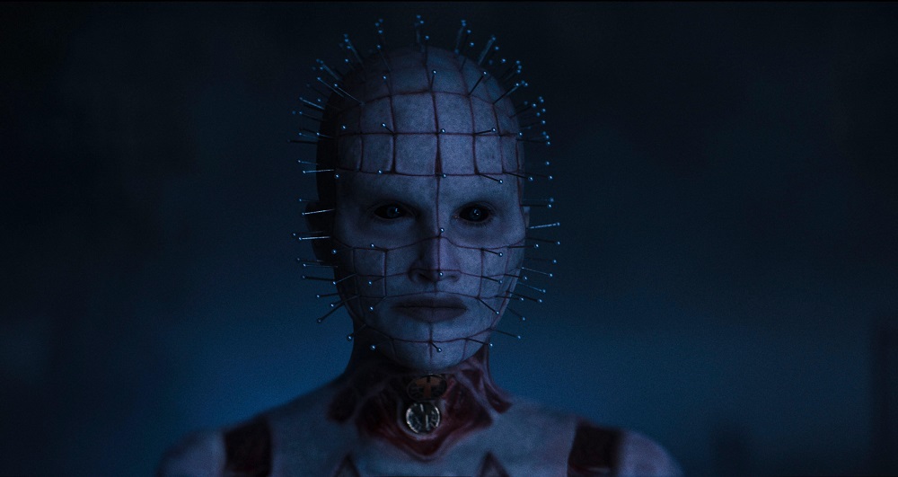 Pinhead offers a penetrating, menacing gaze while standing outside at night in Hellraiser.