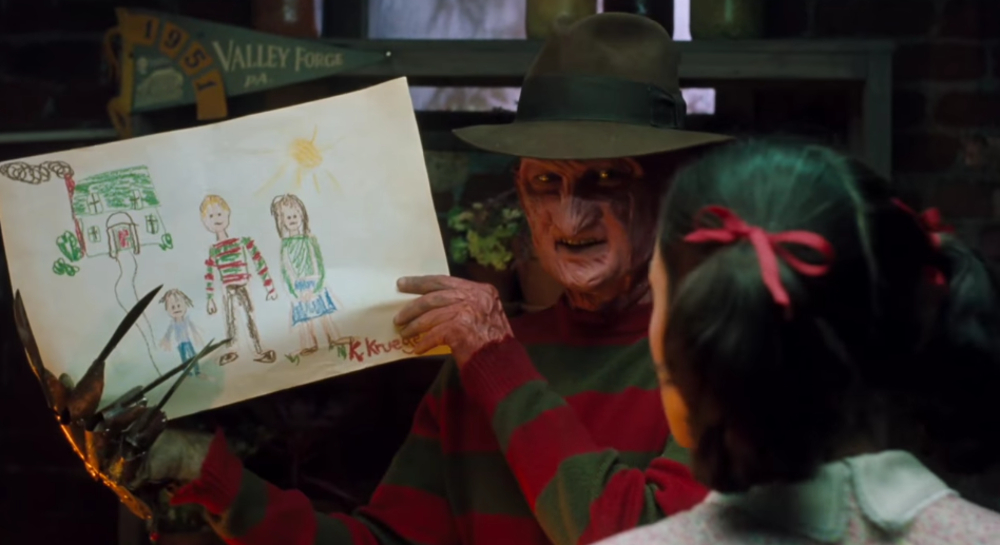 Freddy looks at a picture drawn by his daughter