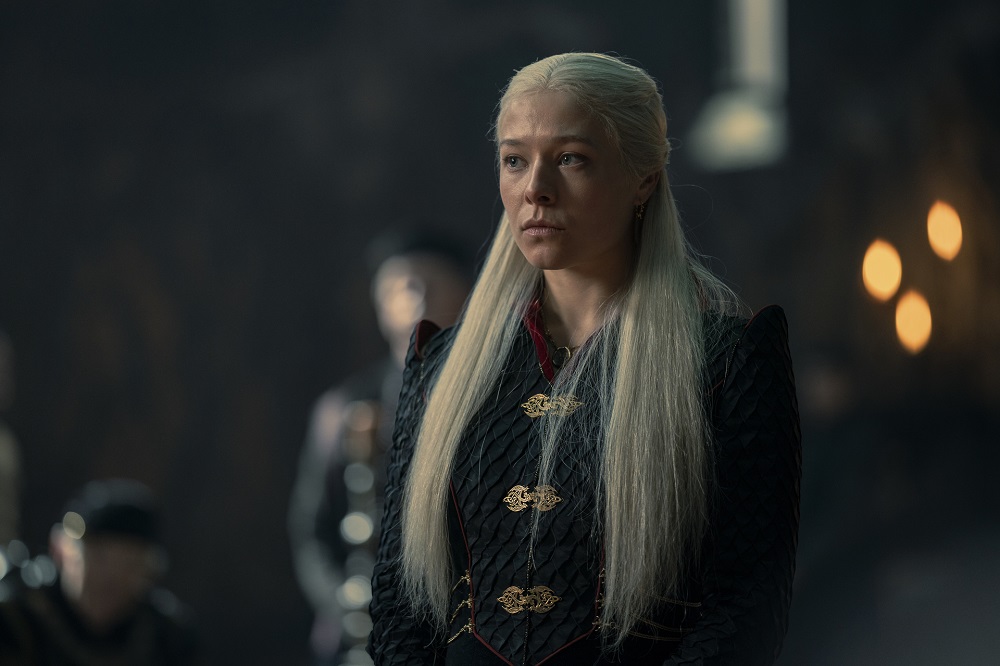 Rhaenyra Targaryen wears a long black coat with dark red accents and a somber expression in House of the Dragon Season 1 Episode 10, "The Black Queen."