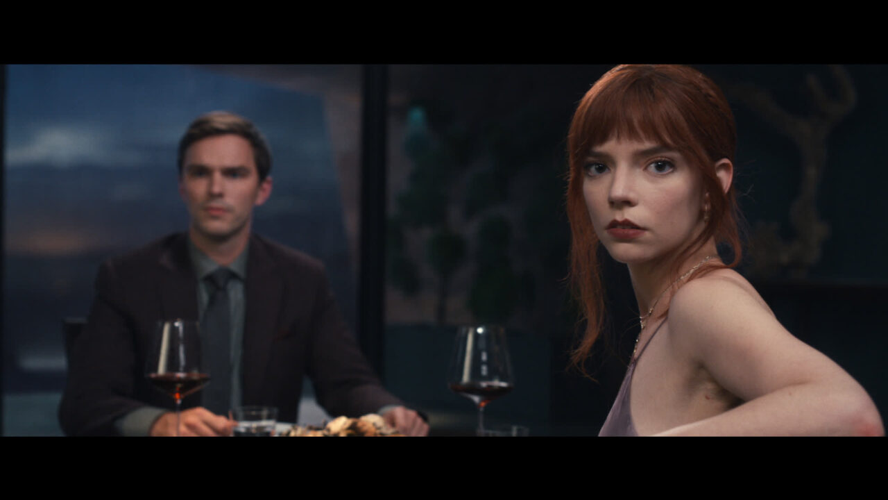 Nicholas Hoult and Anya Taylor-Joy watch the dining room action on The Menu.