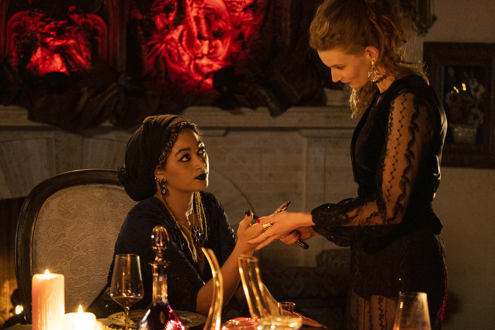 Georgia Waters as Penelope grabs Angela's hands while looking sweetly into her eyes on Reginald the Vampire.