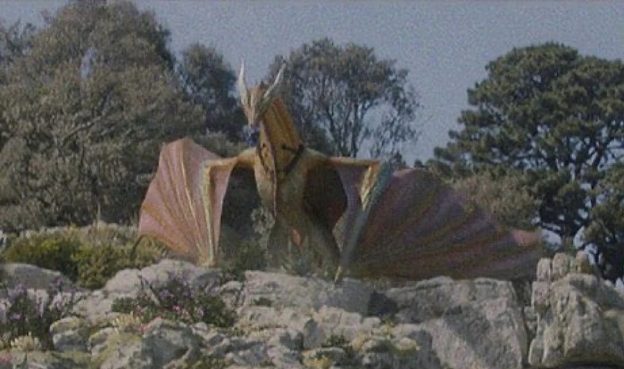 The golden dragon Sunfyre perches outside Driftmark in House of the Dragon.