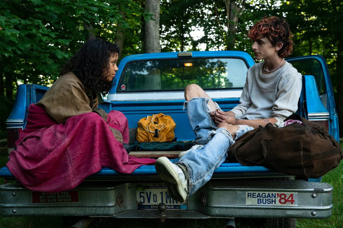 Taylor Russell and Timothée Chalamet relaxes in the back of a truck in Bones and All.