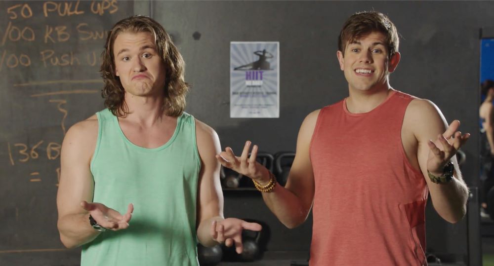 Reilly and Jonesy stand side by side at the gym while shrugging their shoulders in Letterkenny Season 11 Episode 1, "Chips."