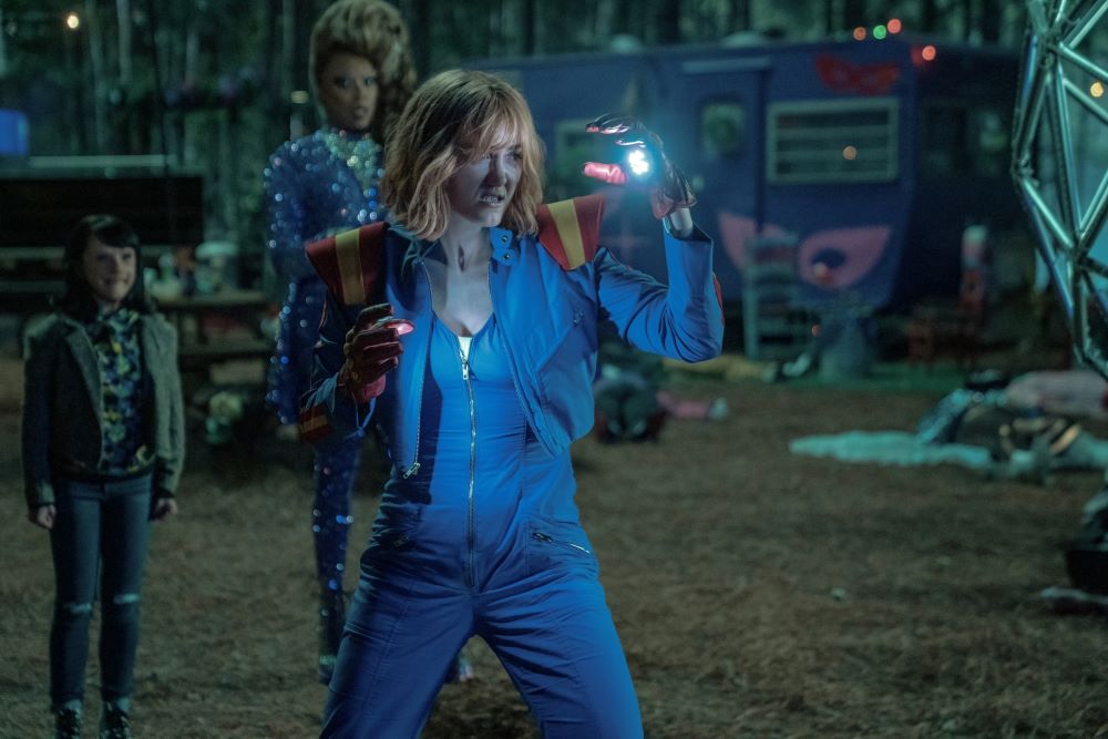 Casey Brinke wears a blue, red, and yellow jumpsuit while emitting light beams from her hands and looking angry in Doom Patrol Season 4 Episode 4, "Casey Patrol."