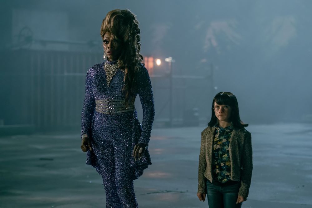 Maura Lee Karupt and Dorothy stand next to each other in a dark parking lot in Doom Patrol Season 4 Episode 4, "Casey Patrol."