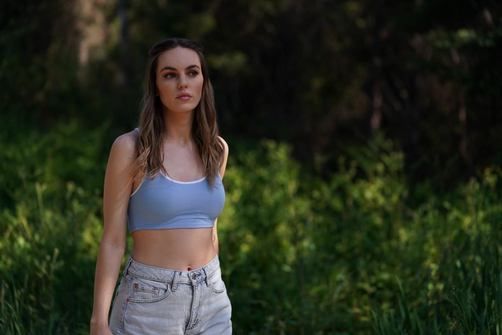 Katy stands outside on a sunny day while looking pensive in Letterkenny Season 11 Episode 3, "Lost Dog."