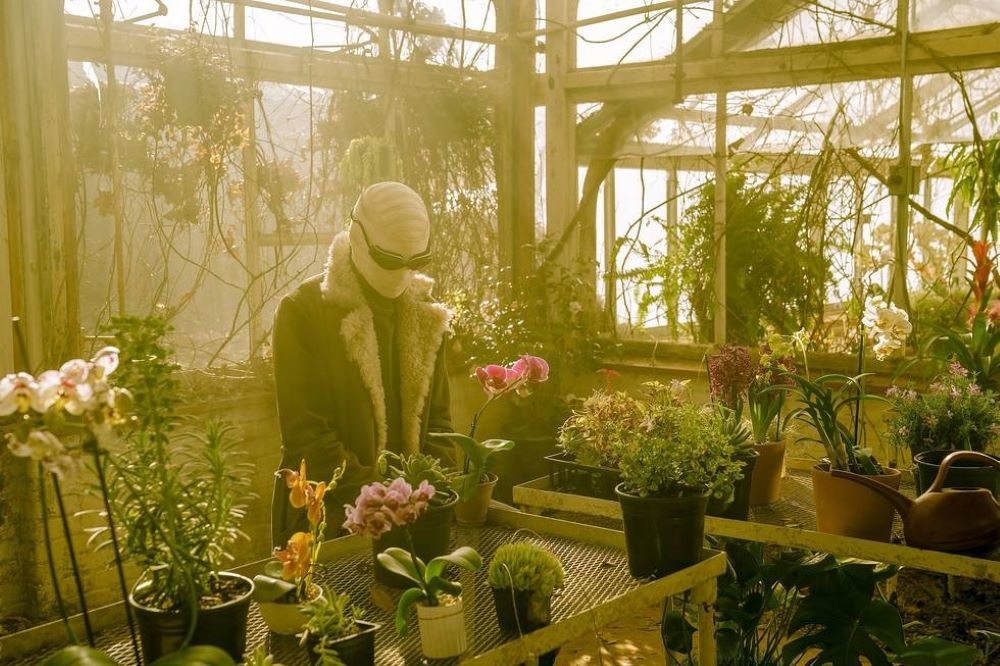 Larry stands in his greenhouse and tends to his plants in Doom Patrol Season 4 Episode 2, "Butt Patrol."