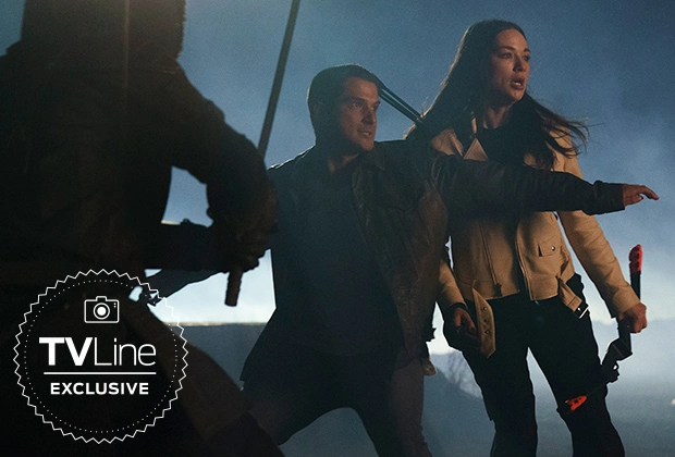 Scott McCall and Allison Argent fight together against an unseen threat in a still from Teen Wolf: The Movie from TVLine