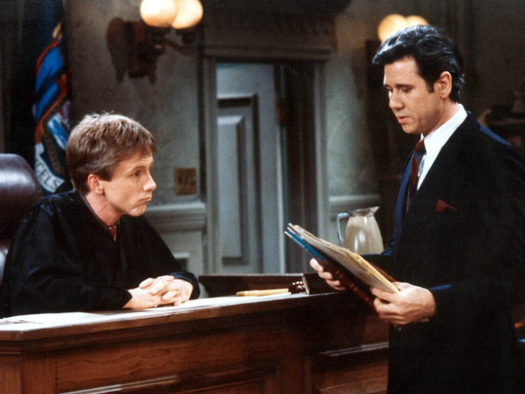 Harry Anderson listens to John Larroquette in Night Court.