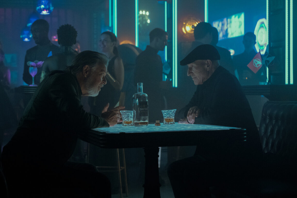 Jonathan Frakes as Riker and Patrick Stewart as Picard in Star Trek: Picard season 3. They are seated in a bar in Stardust City.