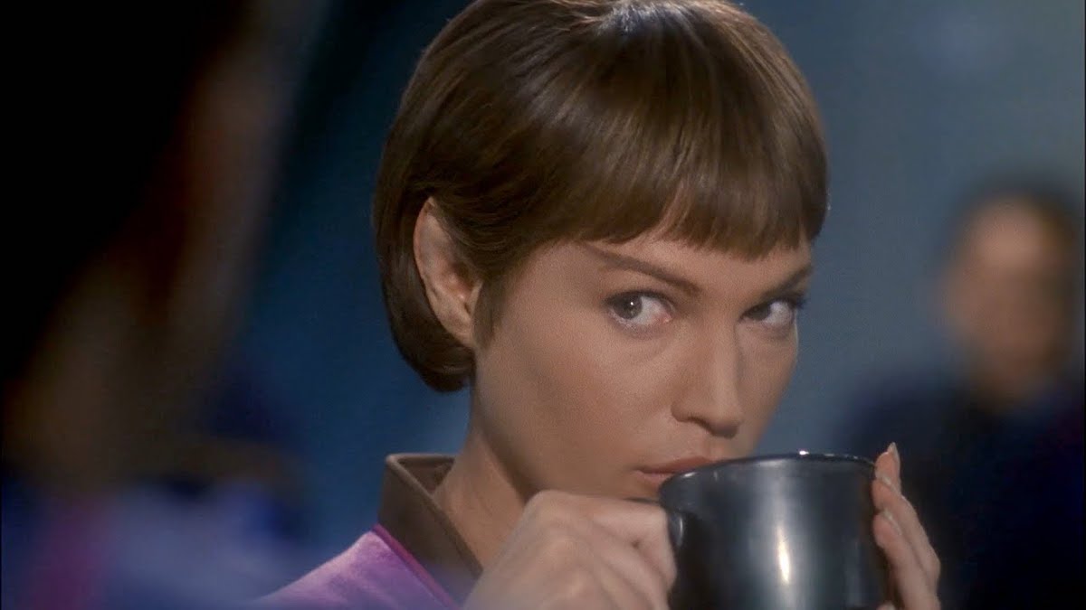 Jolene Block as T'Pol sipping out of a mug in Enterprise.